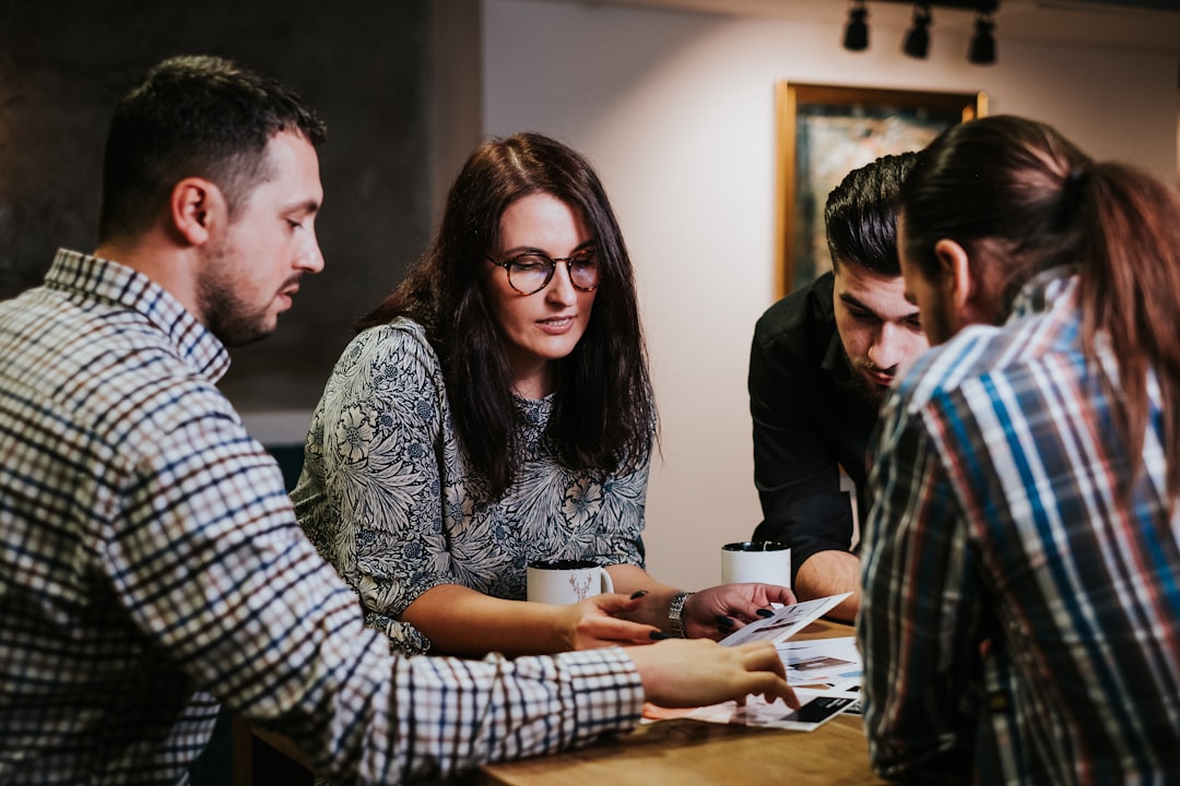 Colleagues reviewing documents together at a table.