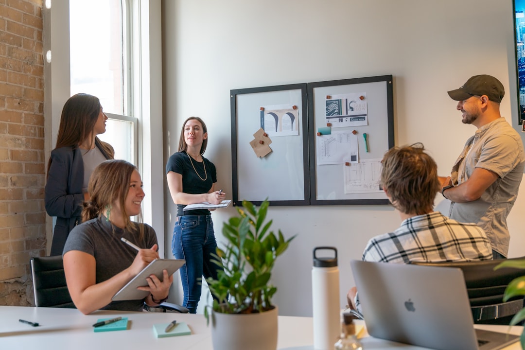 A team reviewing material beside a whiteboard.