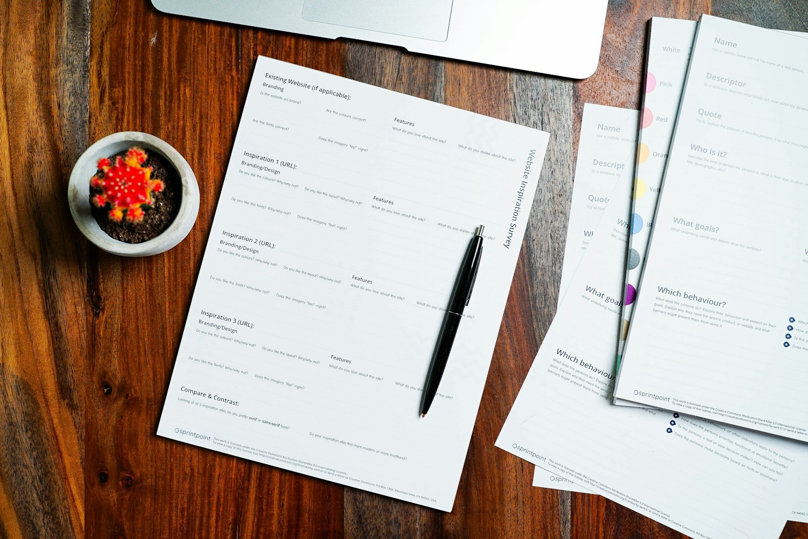 Documents and a pen laid out on a wooden table for review.