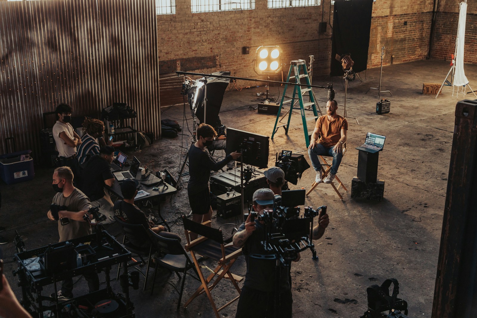 Production crew gathered around a camera setup during filming.